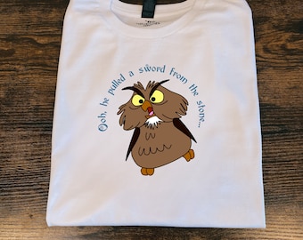 May include: White t-shirt with a cartoon owl and the text "Ooh, he pulled a sword from the stone..."