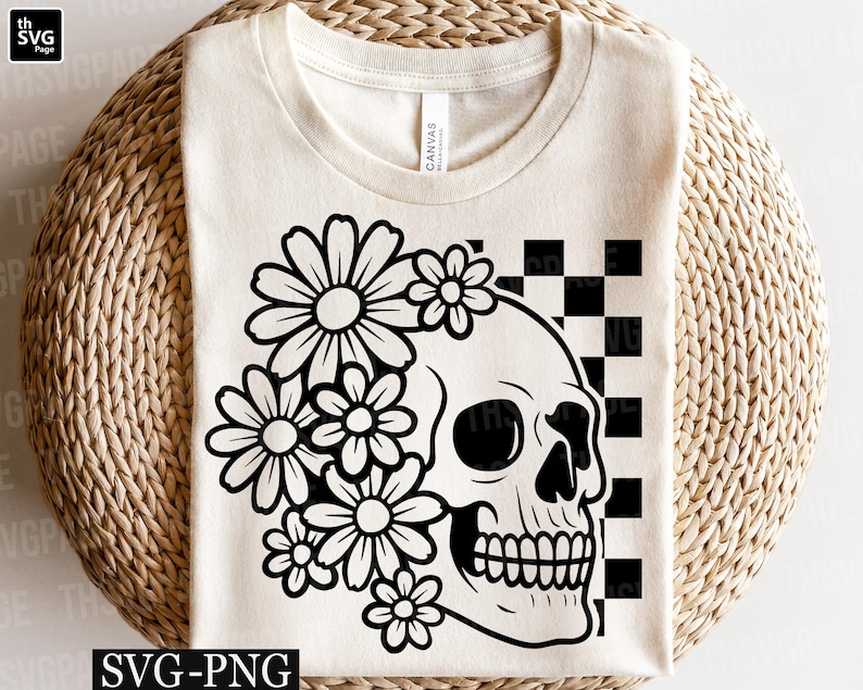 May include: Cream-colored t-shirt featuring a black and white graphic of a skull adorned with daisies, set against a checkered background. The design includes the text "SVG-PNG" at the bottom. A casual, floral-themed design.