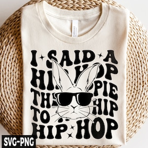 Puede incluir: Una camiseta blanca con un diseño gráfico negro que presenta un conejo con gafas de sol y el texto "I said a hip hop the to hip hop".