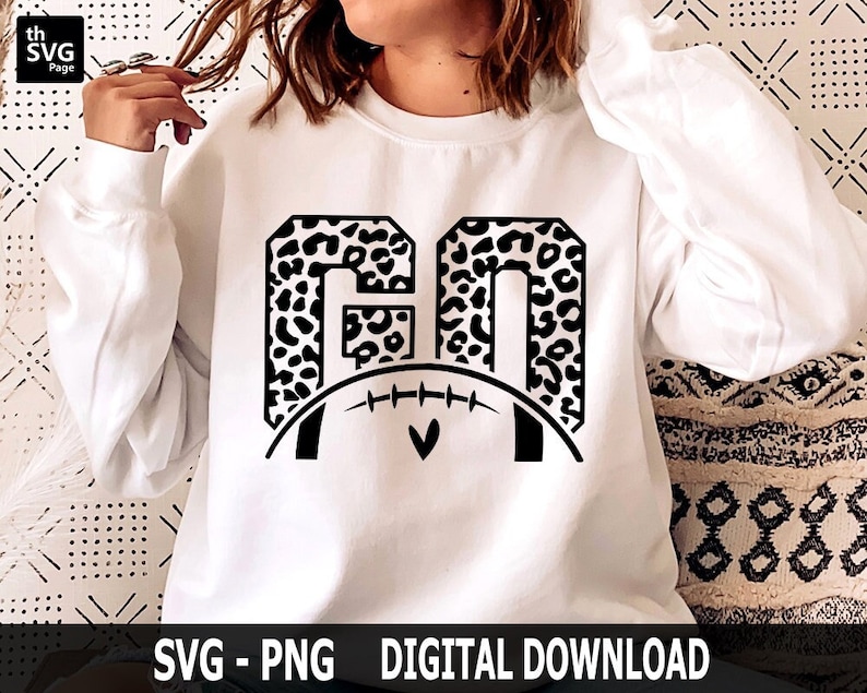 May include: White sweatshirt with a black graphic of the letters "GO" in a leopard print with a football and heart in the center.