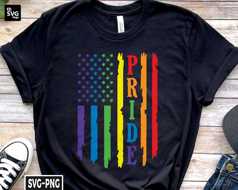May include: Black t-shirt with a rainbow pride flag design and the word "PRIDE" in white letters.