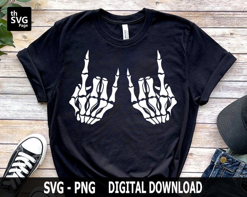 May include: Black t-shirt with a white graphic of two skeleton hands making the rock and roll hand gesture.  "SVG - PNG DIGITAL DOWNLOAD" is printed at the bottom of the image.