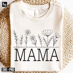 Puede incluir: Camiseta color crema con un diseño floral negro sobre la palabra "MAMA". El diseño floral incluye varias ilustraciones de flores y hojas. La camiseta está hecha de un material suave.