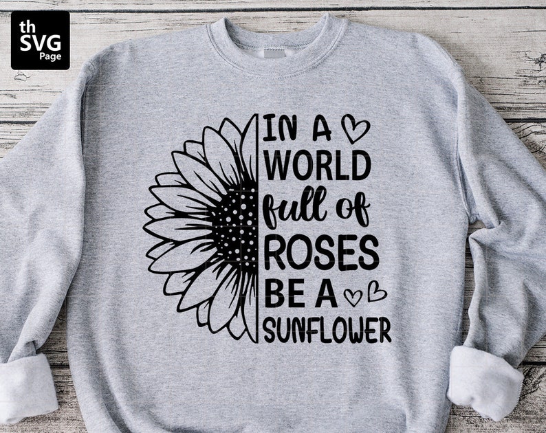 May include: Grey sweatshirt with a black sunflower graphic and the text "In a world full of roses be a sunflower".