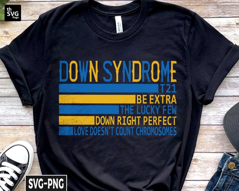 Pode incluir: Camiseta preta com um design listrado azul e amarelo e o texto "Down Syndrome T21 Be Extra The Lucky Few Down Right Perfect Love Doesn't Count Chromosomes".