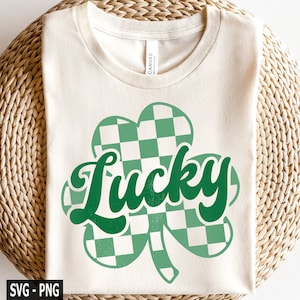 May include: A white t-shirt with a green checkered shamrock and the word "Lucky" in green text.
