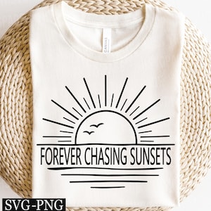 May include: Off-white t-shirt with a black graphic depicting a sunset over water, and the words "FOREVER CHASING SUNSETS". The design includes sun rays, birds, and horizontal lines. The shirt is made of a soft material.