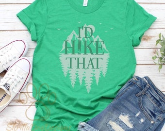 May include: A green t-shirt with a white graphic of mountains and trees. The text "I'd Hike That" is printed on the shirt.