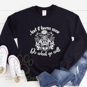 May include: Black sweatshirt with a white graphic print of a moth with a pentagram and the text "And it harm none Do what ye will".