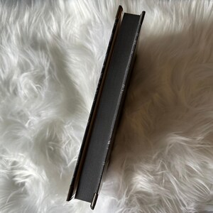 sprayed black edges on a special edition hardcover copy of The Vicious Dark, a stand alone scifi romance with metal corners