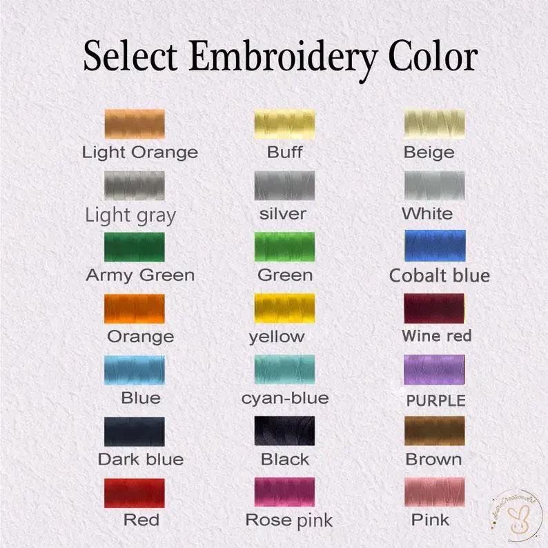 May include: Image displaying a color chart for embroidery thread. The text "Select Embroidery Color" is at the top. The chart shows various thread colors, including light orange, buff, beige, light gray, silver, white, army green, green, cobalt blue, orange, yellow, wine red, blue, cyan-blue, purple, dark blue, black, brown, red, rose pink, and pink.