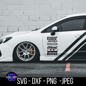 May include: White car with black graphics and text. The text includes "EGGS", "MILK", "BANANAS", "BREAD", "HAM", and "PEPPER". The car has silver rims and a black stripe. The bottom of the image has the text "SVG - DXF - PNG -JPEG".