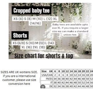May include: Size chart for shorts and cropped baby tees. Includes UK, USA/CAN, FR/ES, IT, and DE size conversions. The chart lists sizes from XS to 2XL for shorts and XS to XL for baby tees. Text states that baby tees are available up to XL.