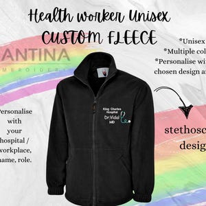 May include: Black fleece jacket with a zipper closure. The jacket has a stethoscope design embroidered on the right chest with the text "King Charles Hospital Dr. Vidal MD".