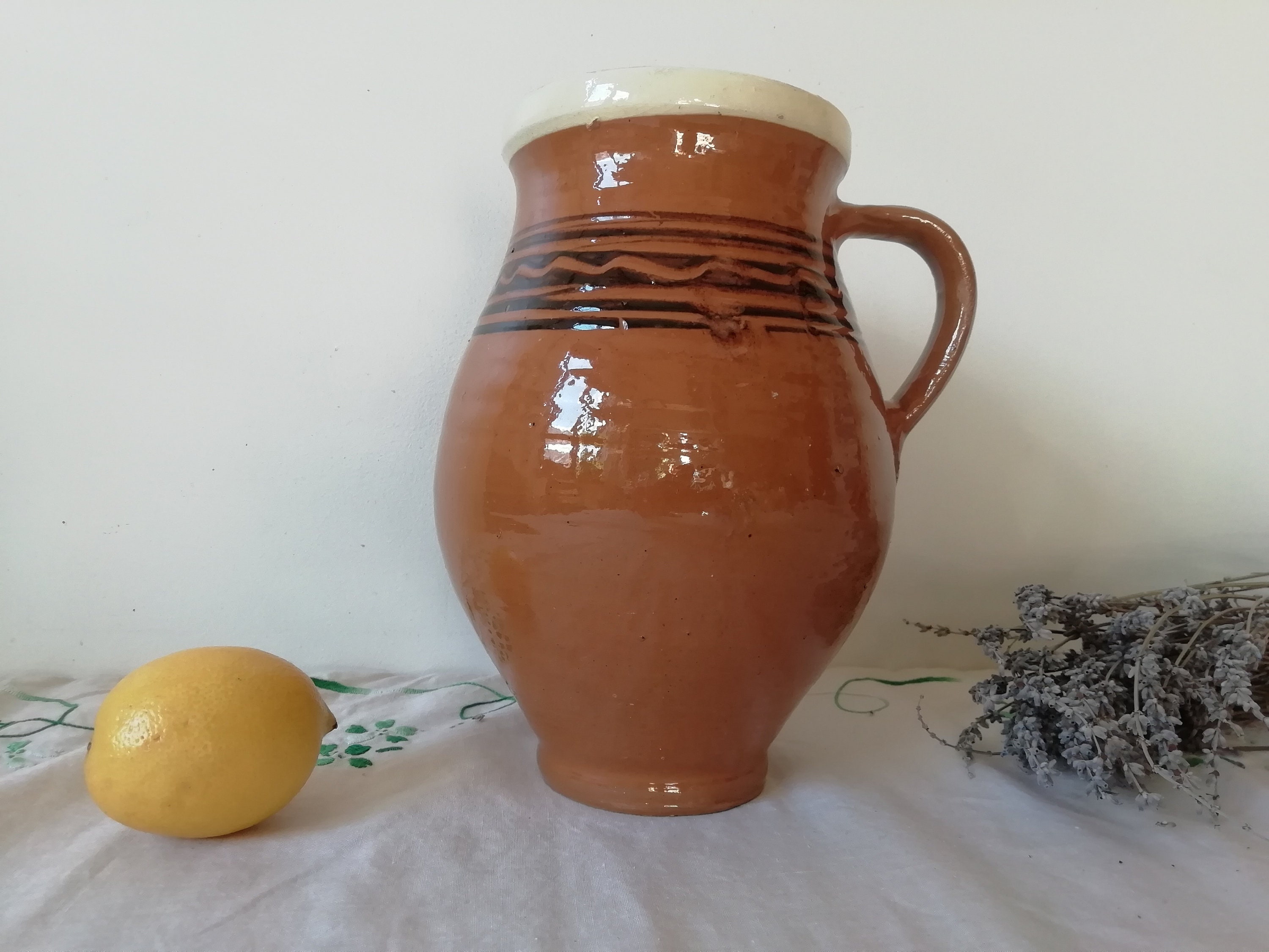 茶色の陶器の原始的な容器の水差し、アンティークの陶器のポット