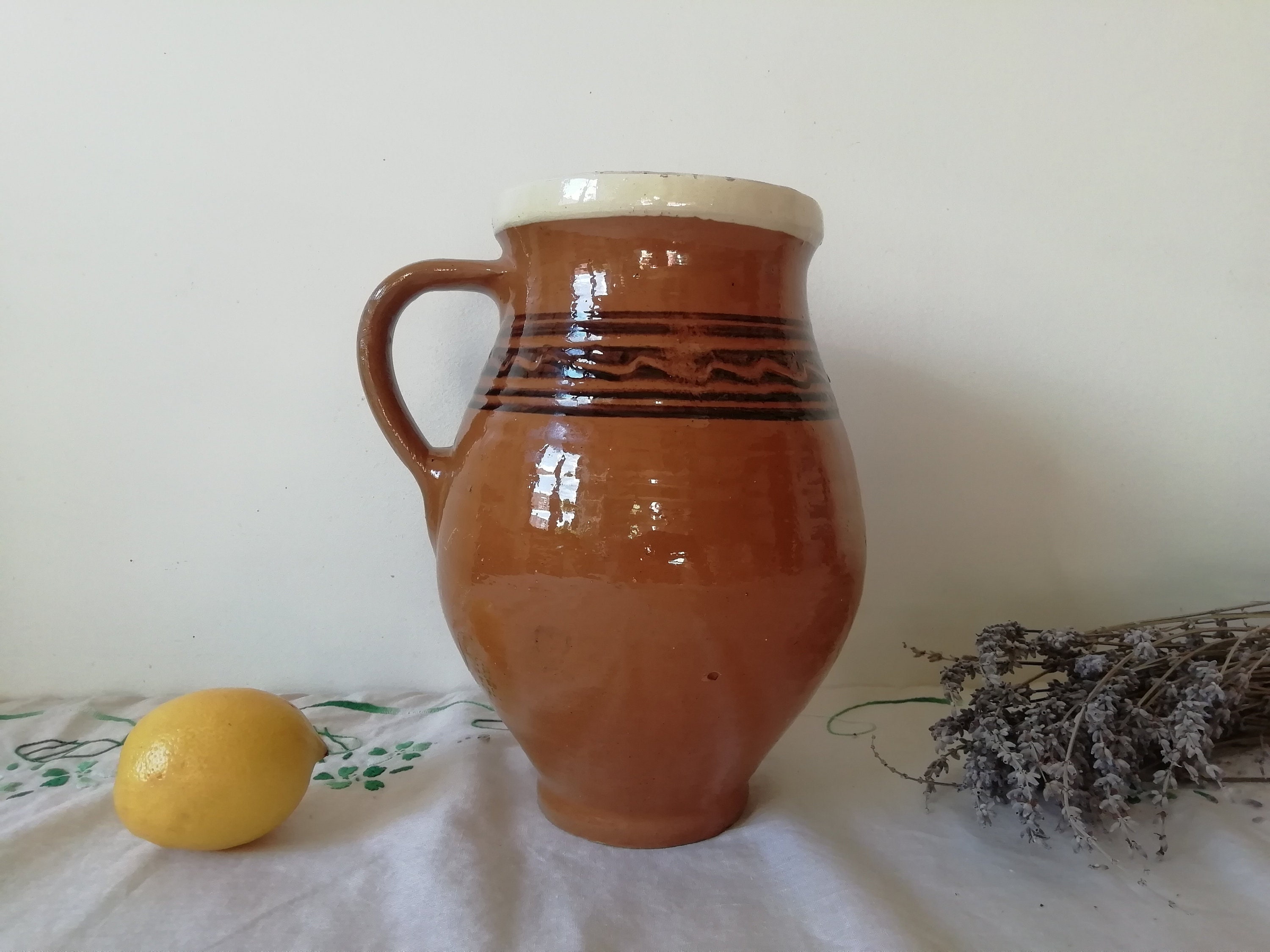 茶色の陶器の原始的な容器の水差し、アンティークの陶器のポット