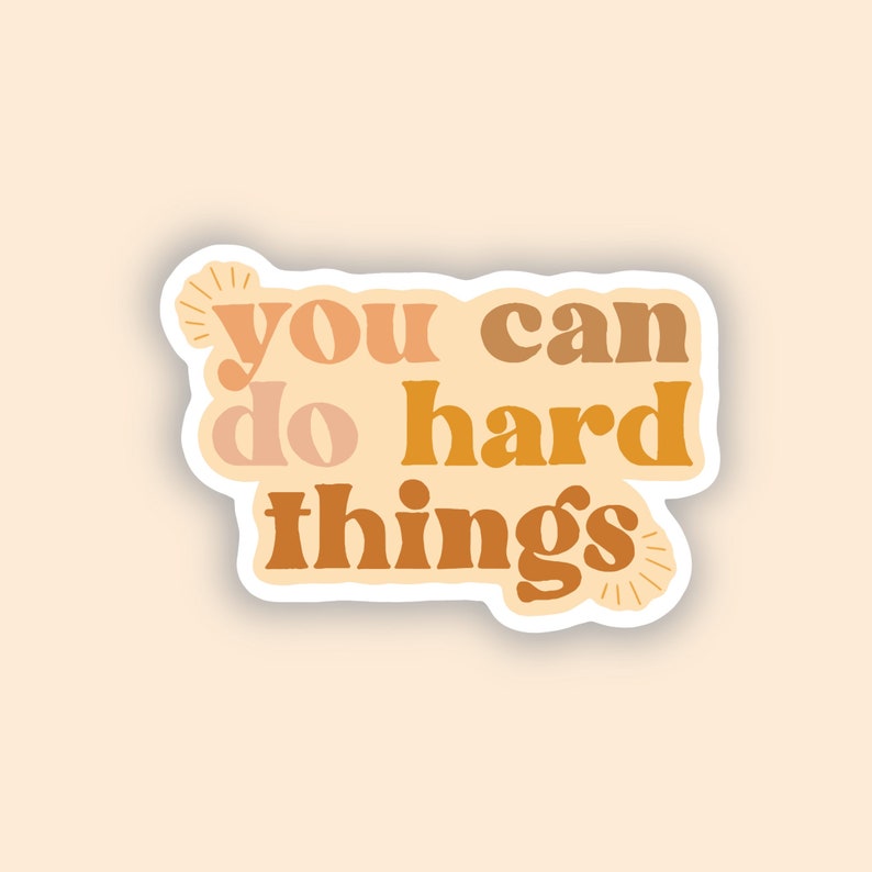 May include: A sticker with the text "You can do hard things" in a retro font style. The text is in shades of orange, brown, and peach.