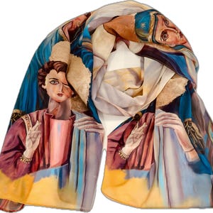 May include: A vibrant silk scarf with a painted religious figure, wearing a burgundy robe and holding a white cloth. The scarf has a blue, yellow, and beige colour palette, with intricate details and a flowing design.