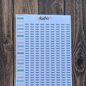 May include: A sheet of stickers with the word "TODAY" repeated multiple times in a white rectangle. The stickers are on a white background and are arranged in rows. The stickers are in various colors, including green, blue, pink, and light blue.