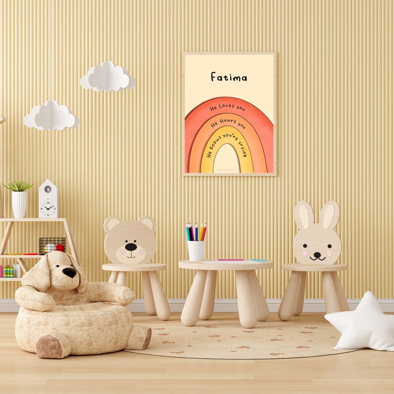 May include: A nursery room with a wooden table and chairs, a plush bear chair, and a framed print with the text "Fatima" and a rainbow with the words "He loves you, He hears you, He knows you're trying".