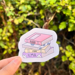 May include: A sticker featuring a stack of books with the words "ILMA", "ZIDNI", and "RABBI" on the spines. The books are illustrated with flowers and are in a cartoon style.