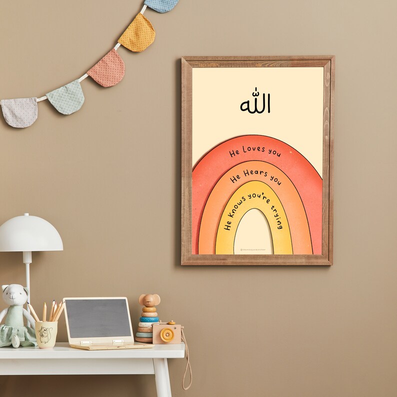 May include: A framed print with a rainbow design and the Arabic word "Allah" in the center. The rainbow has the words "He Loves you", "He Hears you", and "He Knows you're trying" written on it.