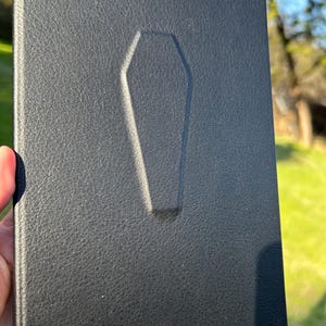 This handmade coffin-style journal embodies bold gothic minimalism; subtle, striking, and unapologetically dark.