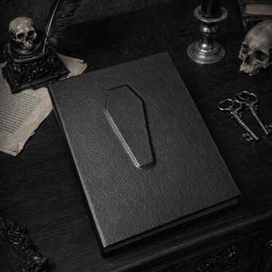 This handmade coffin-style journal embodies bold gothic minimalism; subtle, striking, and unapologetically dark.