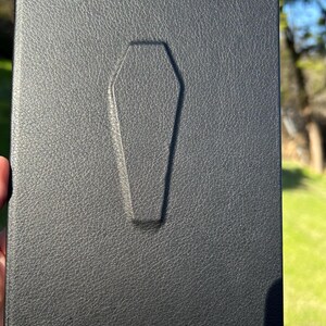 This handmade coffin-style journal embodies bold gothic minimalism; subtle, striking, and unapologetically dark.
