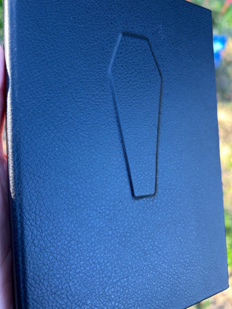 This handmade coffin-style journal embodies bold gothic minimalism; subtle, striking, and unapologetically dark.