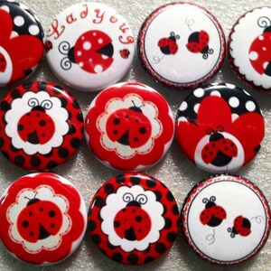 May include: Ten 1-inch round buttons with a ladybug theme. The buttons feature red and black ladybugs on a white background with black polka dots, red polka dots, and a white background with red and black floral designs. Some buttons have the text "Ladybug" on them.