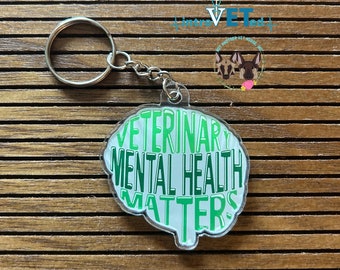May include: Green and white keychain with the text "Veterinary Mental Health Matters" in a brain shape.