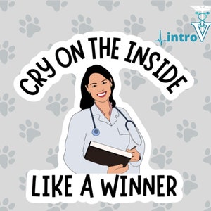 May include: A sticker featuring a smiling cartoon veterinarian holding a notepad and pen, with the text "CRY ON THE INSIDE LIKE A WINNER". The background is light gray with paw prints, and the introVETed logo is in the upper right corner.