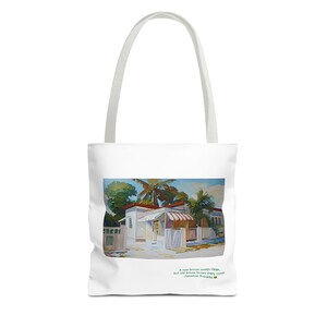 May include: A white tote bag with a colorful painting of a house with a red roof and a palm tree in the background. The text "A new broom sweeps clean, but old brooms know where the happy corners are." is printed on the bag.