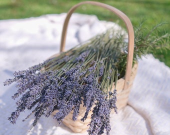 May include: A wicker basket filled with a bouquet of purple lavender flowers.