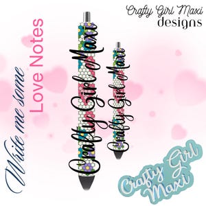 May include: Two colorful pens with a floral pattern and the text "Crafty Girl Maxi" printed on them. The pens are on a pink and white background with the text "Write me some Love Notes" in black.