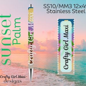 May include: A pen with a colorful design and the text "Crafty Girl Maxi." The pen has a stainless steel tip and a body decorated with a pattern of hexagons in various colors. The background features a beach scene with the words "Sunset Palm."