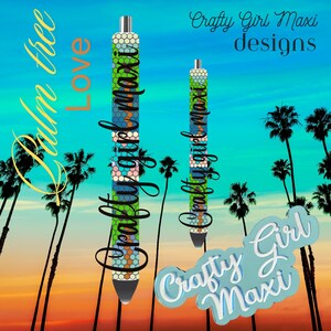 May include: Two colourful patterned pens with the text "Crafty Girl Maxi" on them. The pens are set against a background of palm trees and a sunset sky.