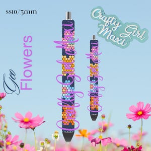May include: Two black pens with colorful geometric patterns. The patterns are made of small squares in shades of blue, pink, orange, and yellow. The pens are labeled "Crafty Girl Maxi".