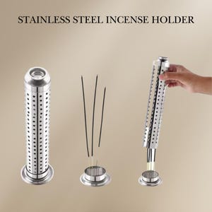 May include: Stainless steel incense holder with a cylindrical design and a perforated base. The holder is shown with incense sticks inserted into the top.