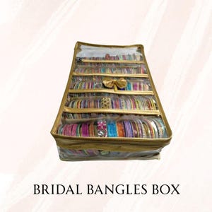 May include: A gold-colored bridal bangles box filled with colorful bangles. The box has multiple compartments and a clear top, with the text "BRIDAL BANGLES BOX" at the bottom.