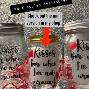 May include: Three glass mason jars with metal lids, each decorated with red hearts and the phrase "Kisses for when I'm not around" in black script. Hershey's Kisses and a silver coin are in front of the jars. Text in the image says "More styles available!" and "Check out the mini version in my shop!"