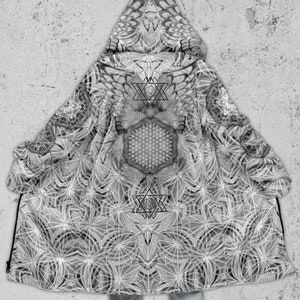 May include: A black and white hooded cloak with a geometric pattern. The pattern features a large hexagon in the centre with smaller hexagons and stars surrounding it.
