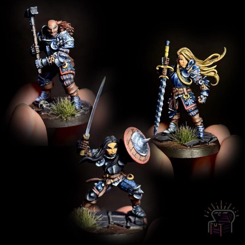 May include: Three hand-painted miniature figures of fantasy warriors. The figures are wearing blue and silver armor and are holding weapons. The figures are standing on small bases with green grass.