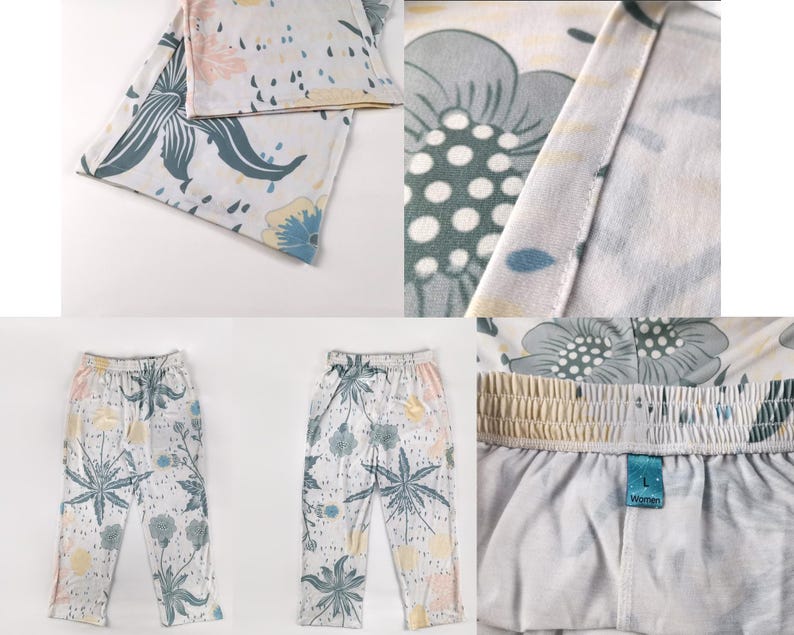 Op de afbeelding: Een witte broek met een bloemenprint in tinten blauw, groen en geel. De broek heeft een trekkoord in de tailleband en een ontspannen pasvorm.