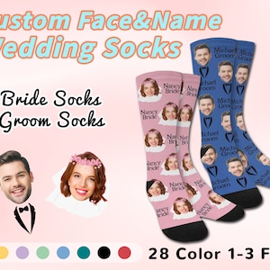 May include: A pair of pink and blue socks with custom faces and names. The socks feature a bride and groom with the text "Nancy Bride" and "Michael Groom". The socks are available in 28 colors and can feature 1-3 faces.
