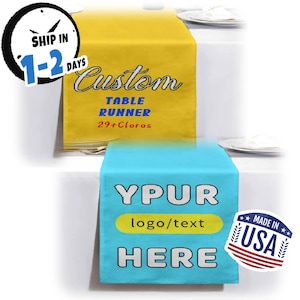 May include: Two custom table runners, one yellow and one blue, are displayed. The yellow runner has the word "Custom" in script, with "TABLE RUNNER" and "29+Cloros" below. The blue runner says "YPUR logo/text HERE".