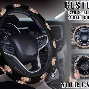 May include: Black car steering wheel cover featuring a repeating pattern of a person's face. The cover is shown on a car steering wheel. The image also includes the text "CUSTOM CAR STEERING WHEEL COVER" and "YOUR FACE".