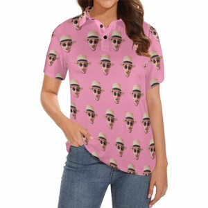 May include: A pink polo shirt with a repeating pattern of a person's face wearing a straw hat and sunglasses.
