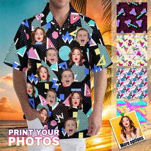 May include: A black and white patterned shirt with colorful geometric shapes and multiple faces printed on it. The shirt has a button-down collar and short sleeves. The text "PRINT YOUR PHOTOS" is printed on the bottom of the image.